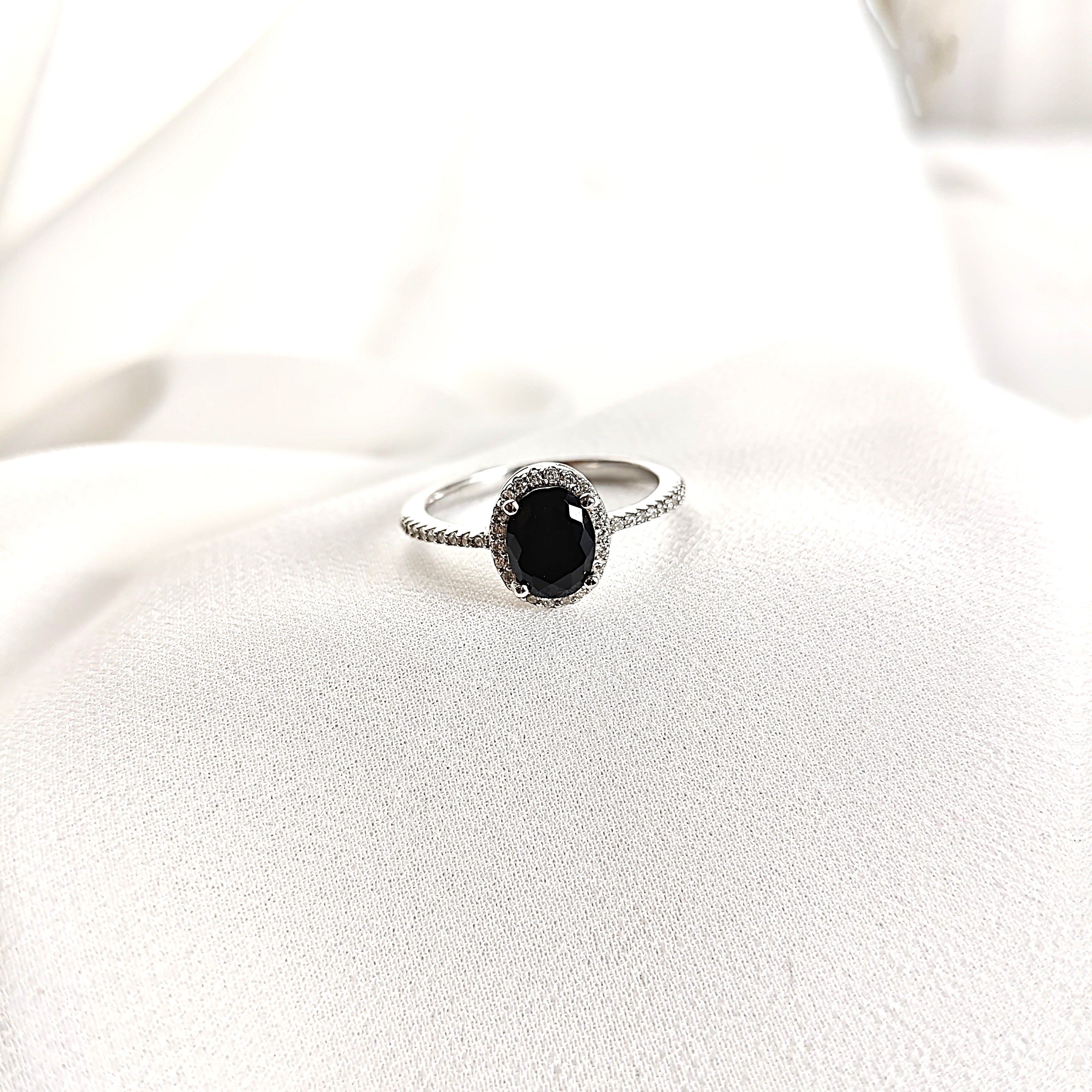 Bague en argent rhodié avec pierre noire et halo de zircons Bague en argent rhodié avec pierre noire et halo de zircons