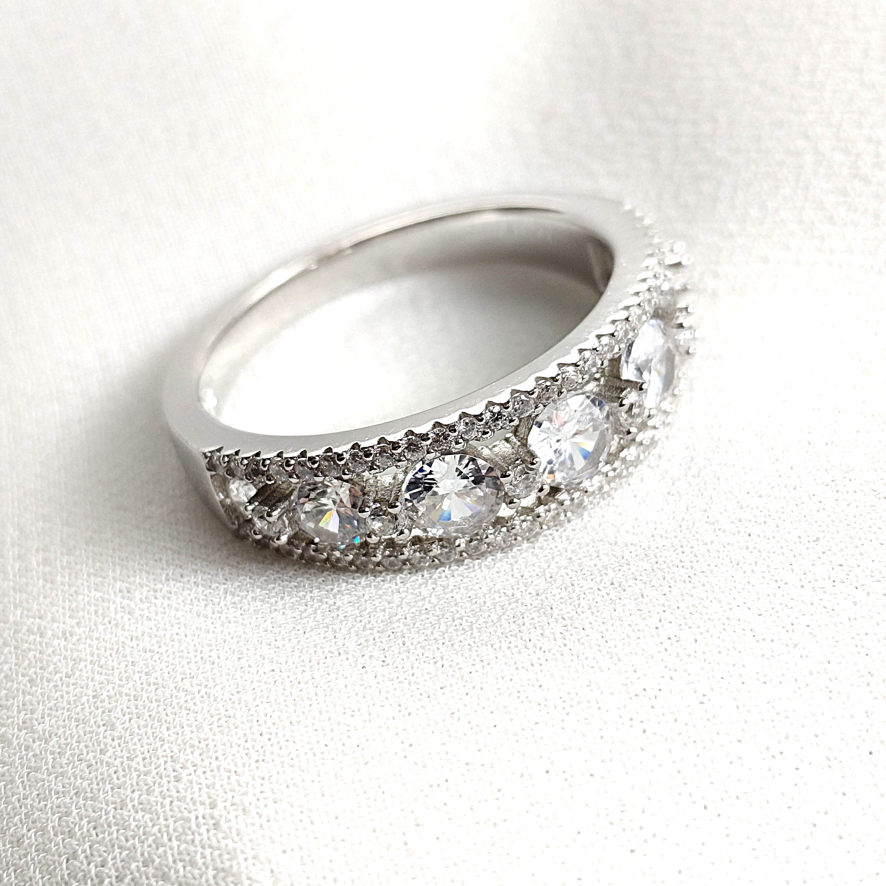 Bague en argent rhodié sertie de cinq zircons scintillants Bague en argent rhodié sertie de cinq zircons scintillants