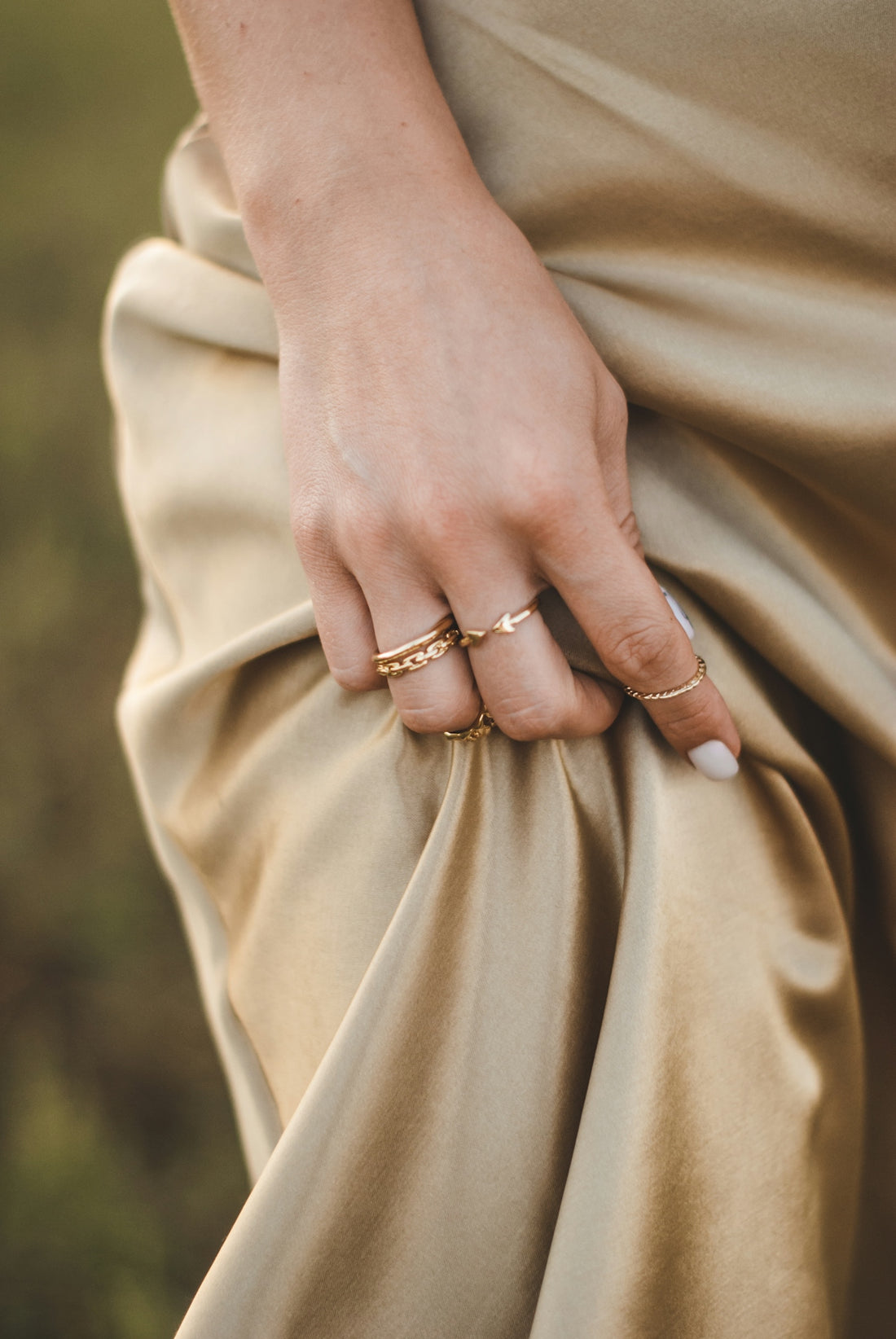 person wearing gold ring and gold ring