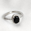 Bague en argent rhodié avec pierre noire et halo de zircons