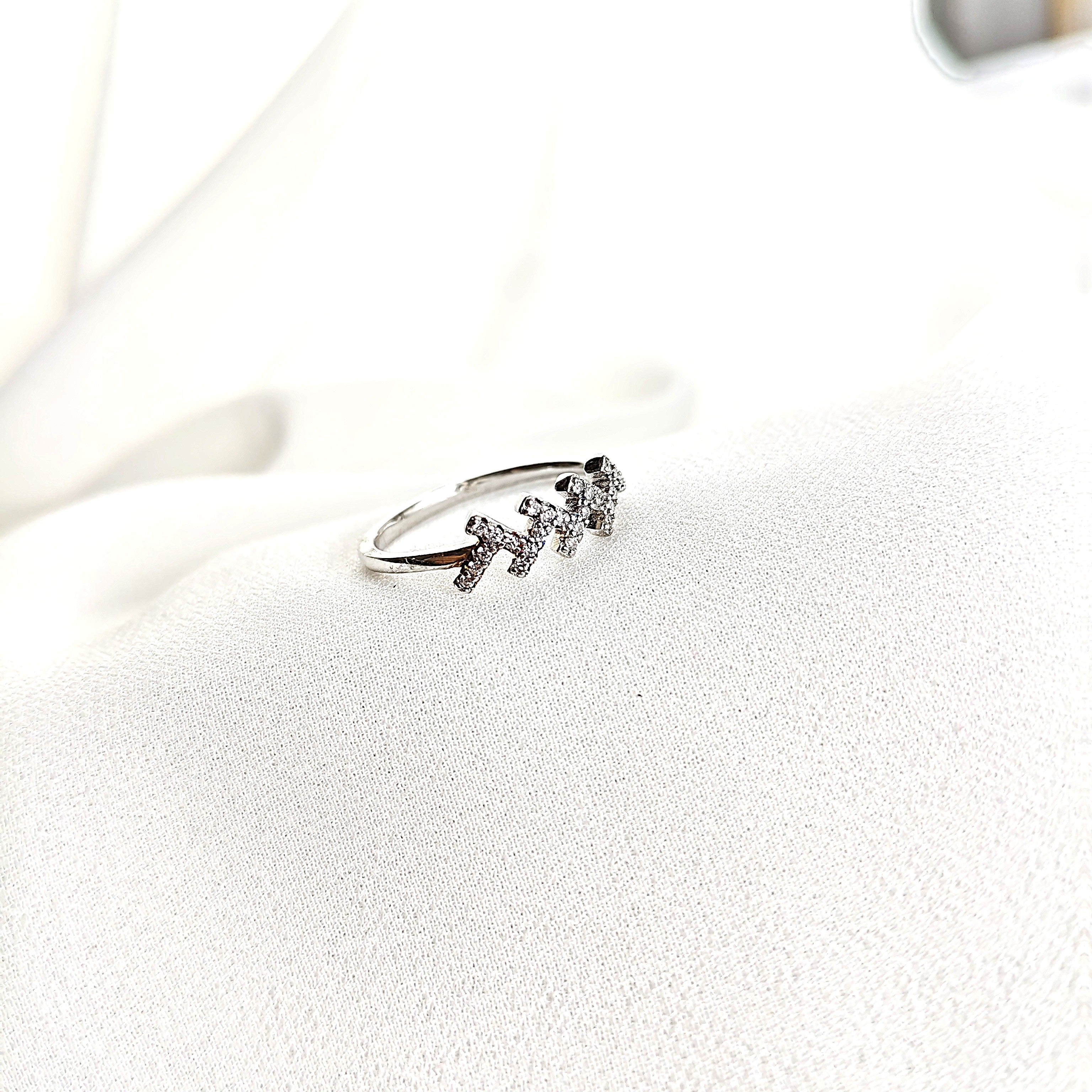 Bague en argent rhodié avec motif triple H serti de zircons