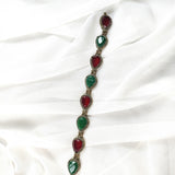 Gourmette antique en bronze avec pierres vertes et rouges