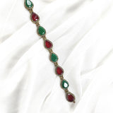 Gourmette antique en bronze avec pierres vertes et rouges