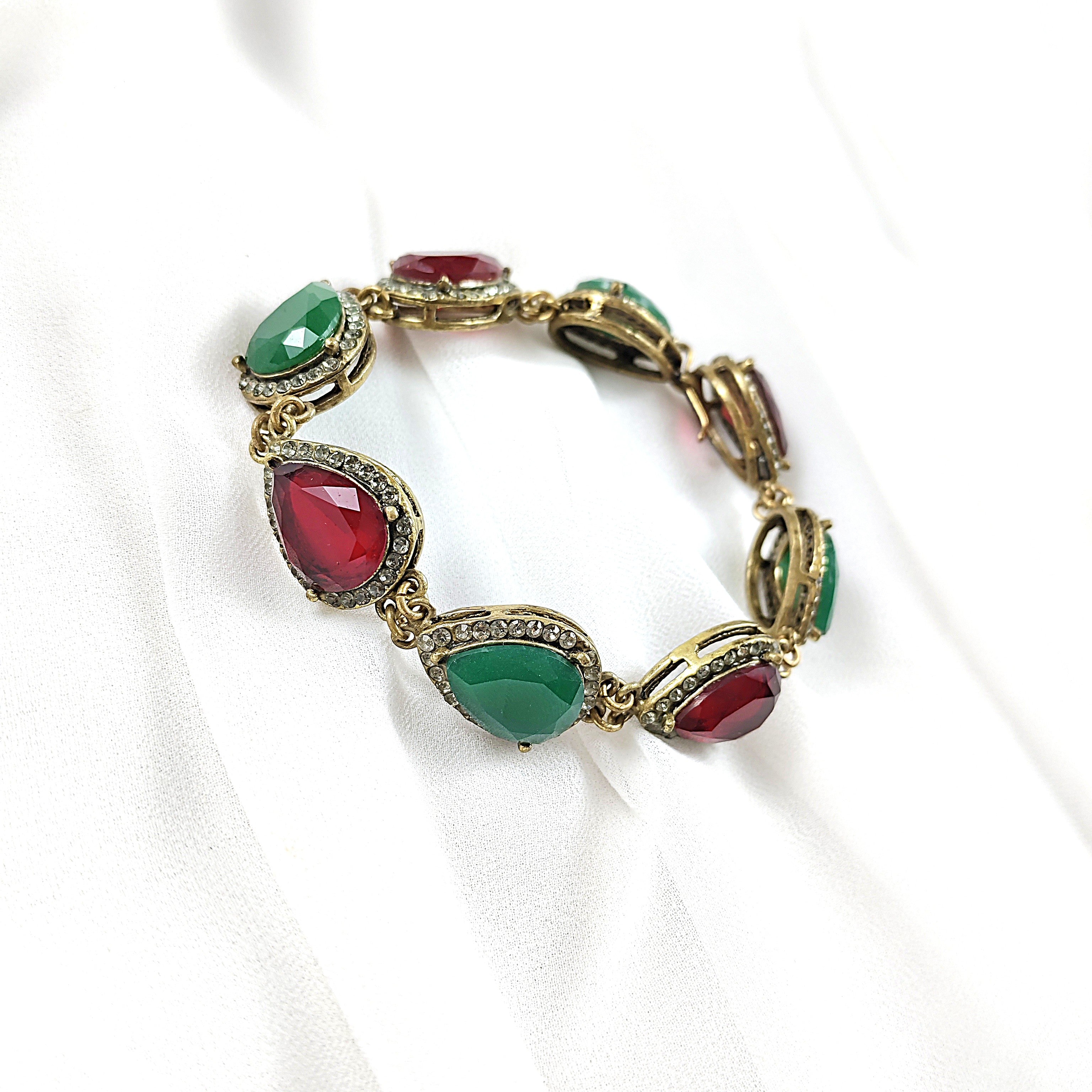 Gourmette antique en bronze avec pierres vertes et rouges