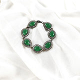 Gourmette antique en bronze avec pierres vertes