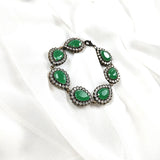 Gourmette antique en bronze avec pierres vertes