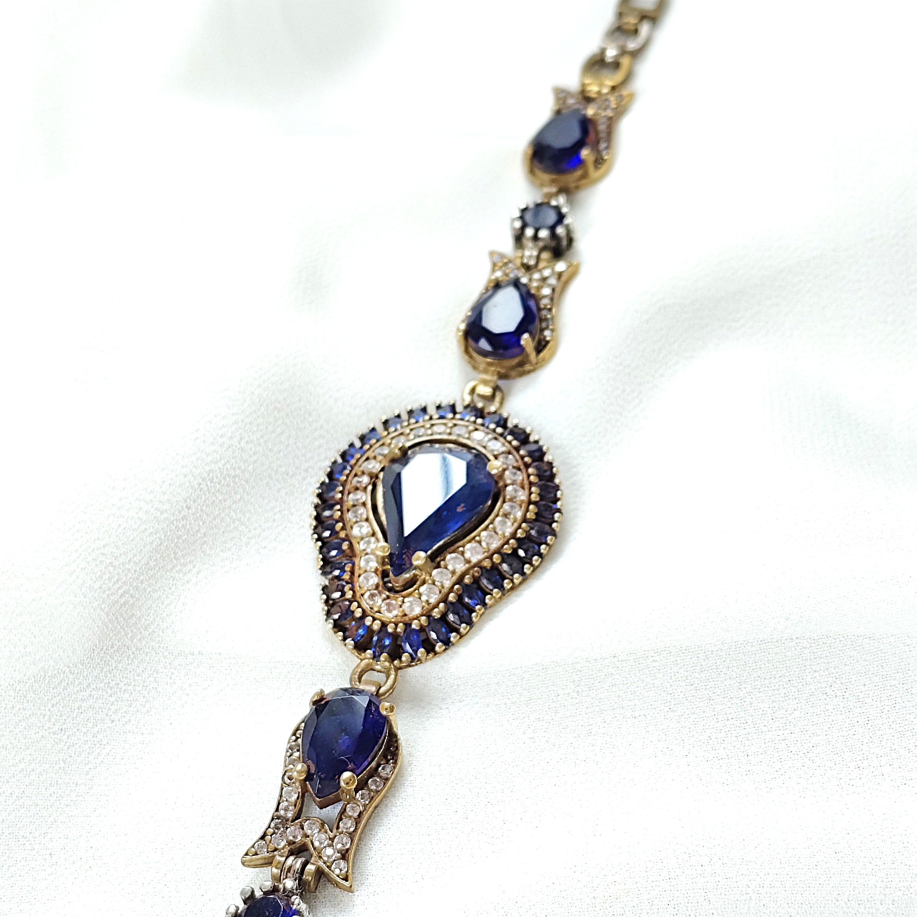 Gourmette antique en bronze avec pierres bleues royales