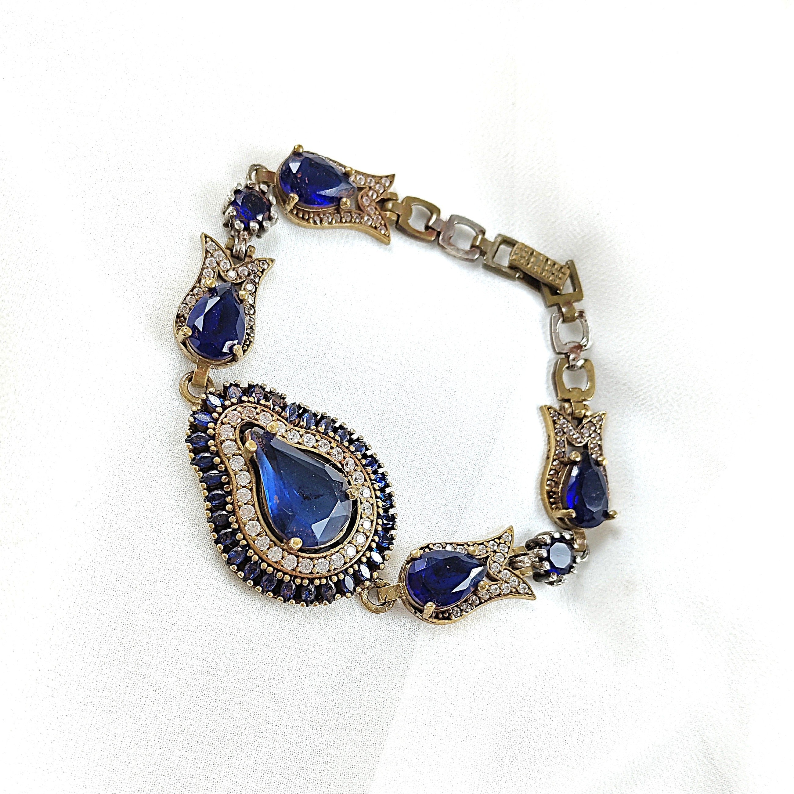 Gourmette antique en bronze avec pierres bleues royales