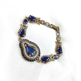 Gourmette antique en bronze avec pierres bleues royales